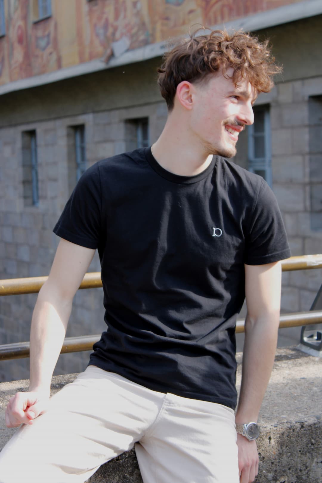 The Standard T-Shirt worn seated in the old town