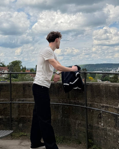 The Standard Trousers in black, worn with a white tee