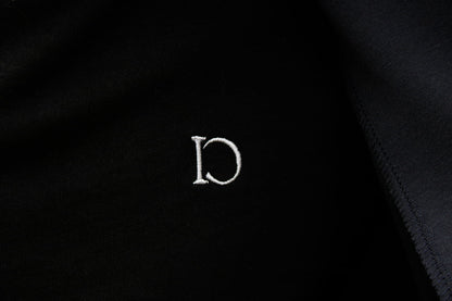 Close-up of the embroidered emblem on The Standard T-Shirt
