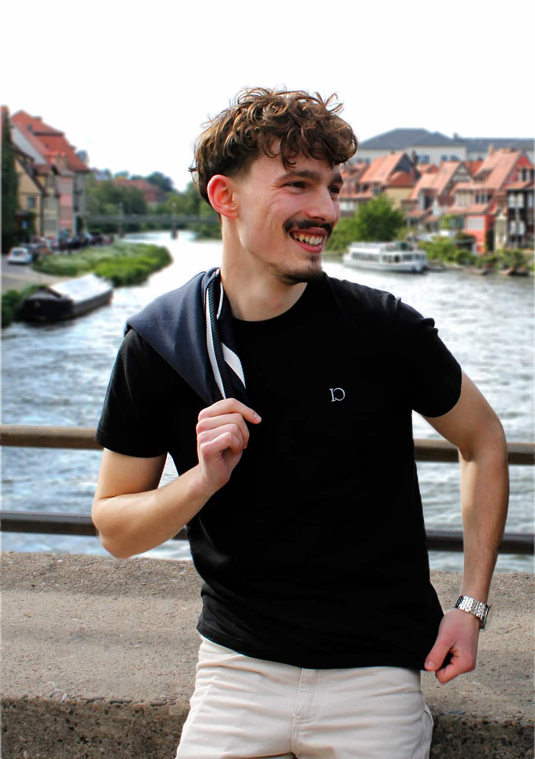 The Standard T-Shirt in black, worn by the river